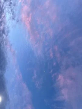 The moon in the sunset sky. Stock Photos