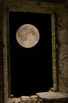Moon through ancient stone window Stock Photos