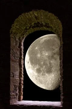 Moon through ancient stone window Stock Photos