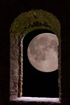 Moon through ancient stone window Stock Photos