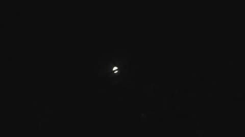 Moon through the branches of trees. A full moon in the night sky. Stock Footage 157562025