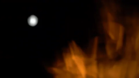 Moon through the fire flame Stock Footage 64474674