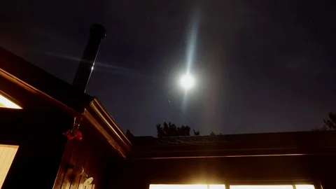 Moon Time Lapse over Cottage Stock Footage 72596538