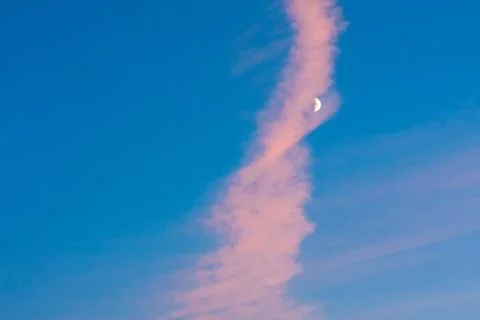 Moon under pink cloud on blue sky Stock Photos