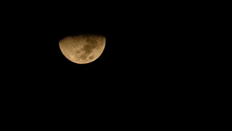 The moon was obscured by some clouds as it set. Stock Footage 262774352