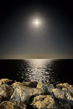 Moonlight creates a shimmering path across the calm Mediterranean Sea Photos