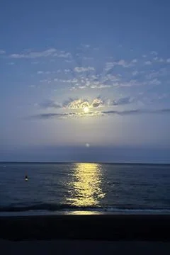Moonlight creates a shimmering path across the calm Mediterranean Sea Foto stock