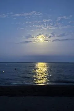 Moonlight creates a shimmering path across the calm Mediterranean Sea Photos