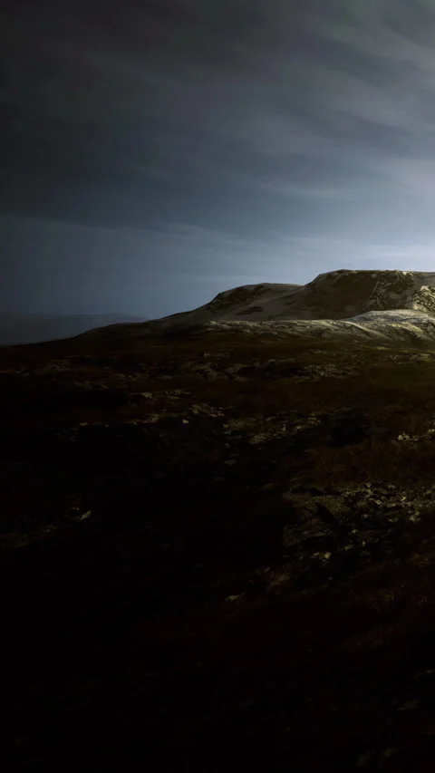 Moonlight illuminates a serene mountain landscape at twilight in the wilderness Stock Footage 334251153