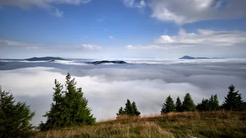 Moonlight Illuminating Clouds Over Misty Mountain Landscape in Night Timelapse Stock Footage 317643450