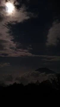 Moonlight Over a Cloud-Covered Mountain Peak Stock Photos