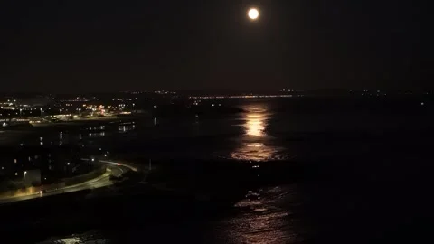 Moonlight reflecting on waterfront at night in Lisbon, Portugal Stock Footage 282363172