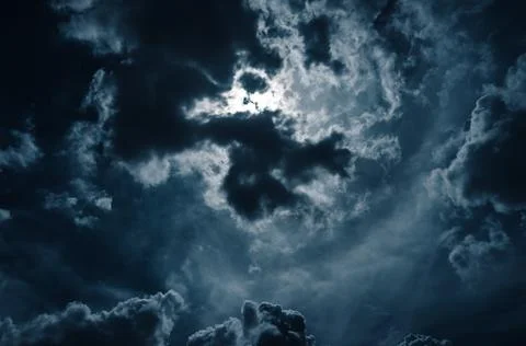 Moonlight shines behind a cloudy at night. serenity nature background. Stock Photos