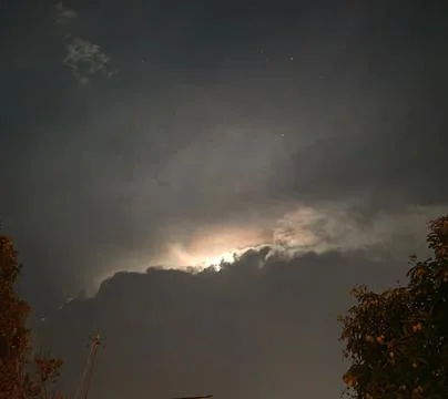 Moonlight Shining Through Clouds at Night 스톡 사진