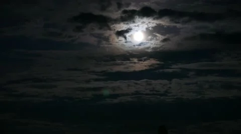 Moonlit night, moon with clouds in a dark sky - timelapse  Video stock 54220763