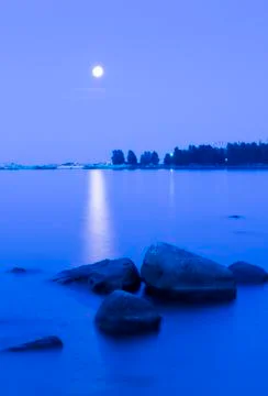 Moonlit path on the lake at night Фото