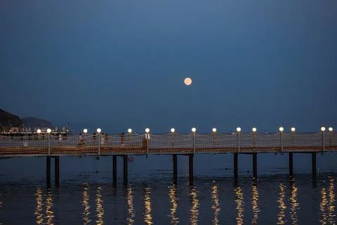 Moonlit Pier at Twilight with Reflections Stock Photos
