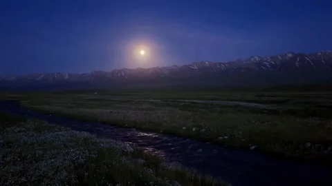 Moonlit River Through Grassy Plains Towards Snow-Capped Mountains, Tibetan Видео 337912834