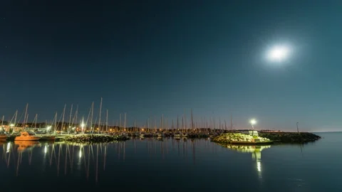 Moonlit Sailboat Marina Reflected on Calm Water at Night Stock Footage 344128500