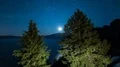 Moonrise moonlight and stars reflected on Crater Lake National Park Tilt Up 4k or 4k+ Resolution
