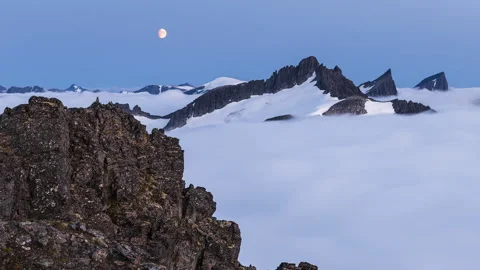 Moonset over mountains in the embrace of inversion Stock Footage 250432743