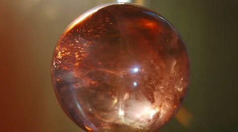 Moonstone crystal ball - orange back Stock Footage 1046699