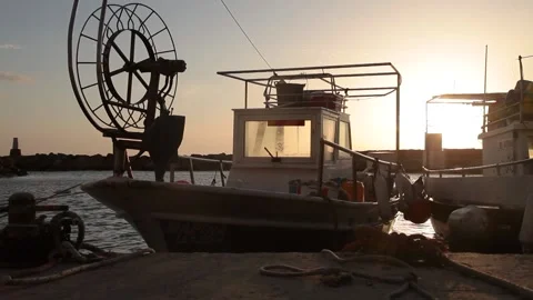 Moored boat bobs on the waves at sunset Stock Footage 171657085