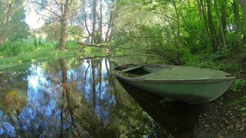 A moored boat on a quiet river Stock Footage 162166372
