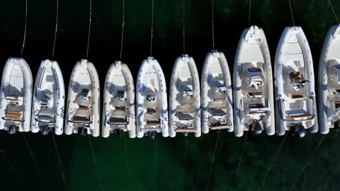 The moored dinghies gently rock on the waves. Top-down drone shot. Stock Footage 260615151