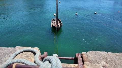 Moored Sailboat Below Stone Quay in Brittany, France Stock Footage 340586163