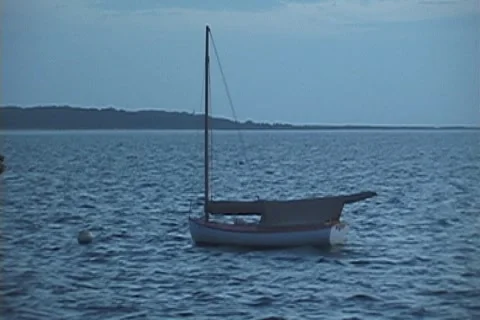 Moored sailboat at dusk Stock Footage 904389