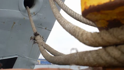 Moored Ship Swinging on Waves Moving Mooring Ropes Up and Down on Bollard Stock Footage 126232392