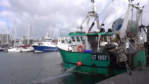 Moored trawler emptying bilges Stock Footage 137859883