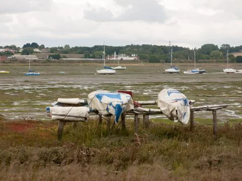 Moored upside down boats on the edge of manningtree estuary scene Stock Photos