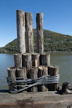 Mooring posts on a river pier Stock Photos