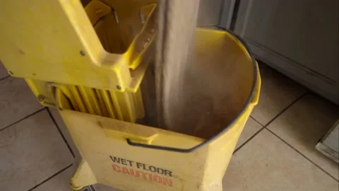 Mop goes into mop bucket side view Video stock 144457932