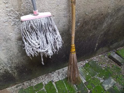 The mop is hanging up because it is no longer used Stock Photos
