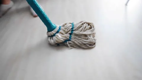The mop slides across the floor while the landlady cleans the apartment Stock Footage 313891851