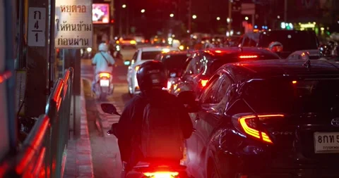 Moped riders navigate traffic jam. practicality mopeds traffic jams Stock Footage 268668386