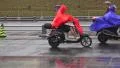 Moped Riders Rainy Day In China 4k or 4k+ Resolution