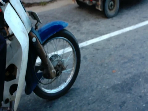A moped wheel on the road 库存影片 69855406