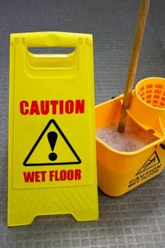 Mopping floor warning sign Stock Photos