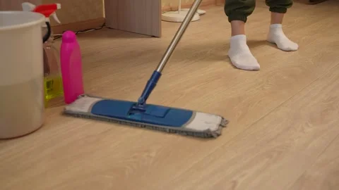 Mopping the floors with a mop using safe household cleaning products. Removing 스톡 동영상 311051454