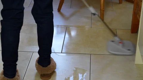Mopping the kitchen floor with a wet mop Stock Footage 323443539