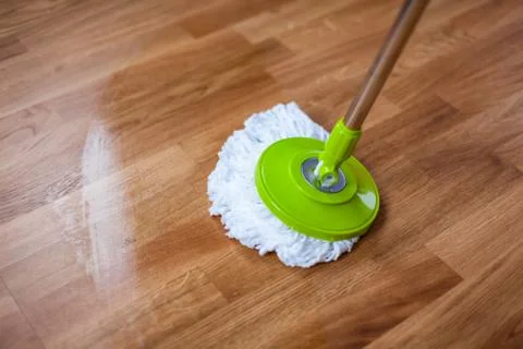 Mopping parquet with mop. Stock Photos
