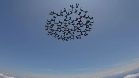 More than 100 skydivers together in a large formation. Video stock 341170359