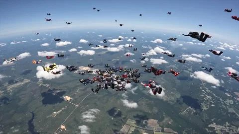 More than 100 skydivers together in a large formation. Video stock 341271439