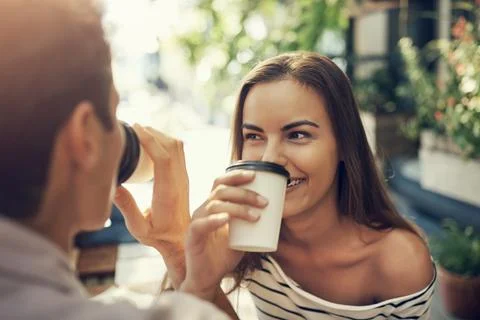More than just work colleagues. two creative employees toasting with coffee cups Stock Photos