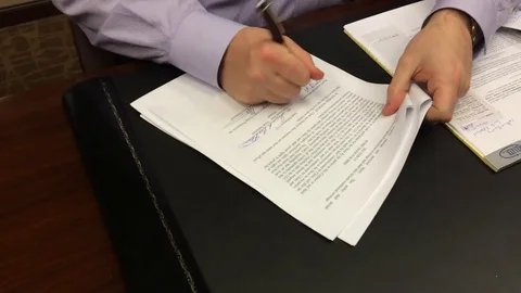 More signing documents Stock Footage 74478280