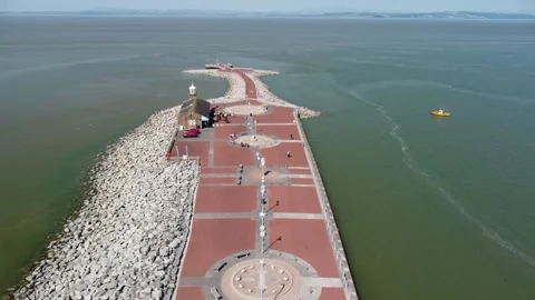 Morecambe - drone flies above stone jetty at high tide Stock Footage 204774651